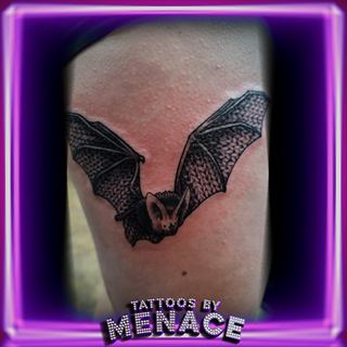Black and grey bat tattoo on the shoulder