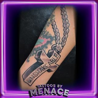 UNSHAKEABLE banner and chain forearm tattoo
