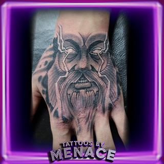 Black and grey bearded god head hand tattoo