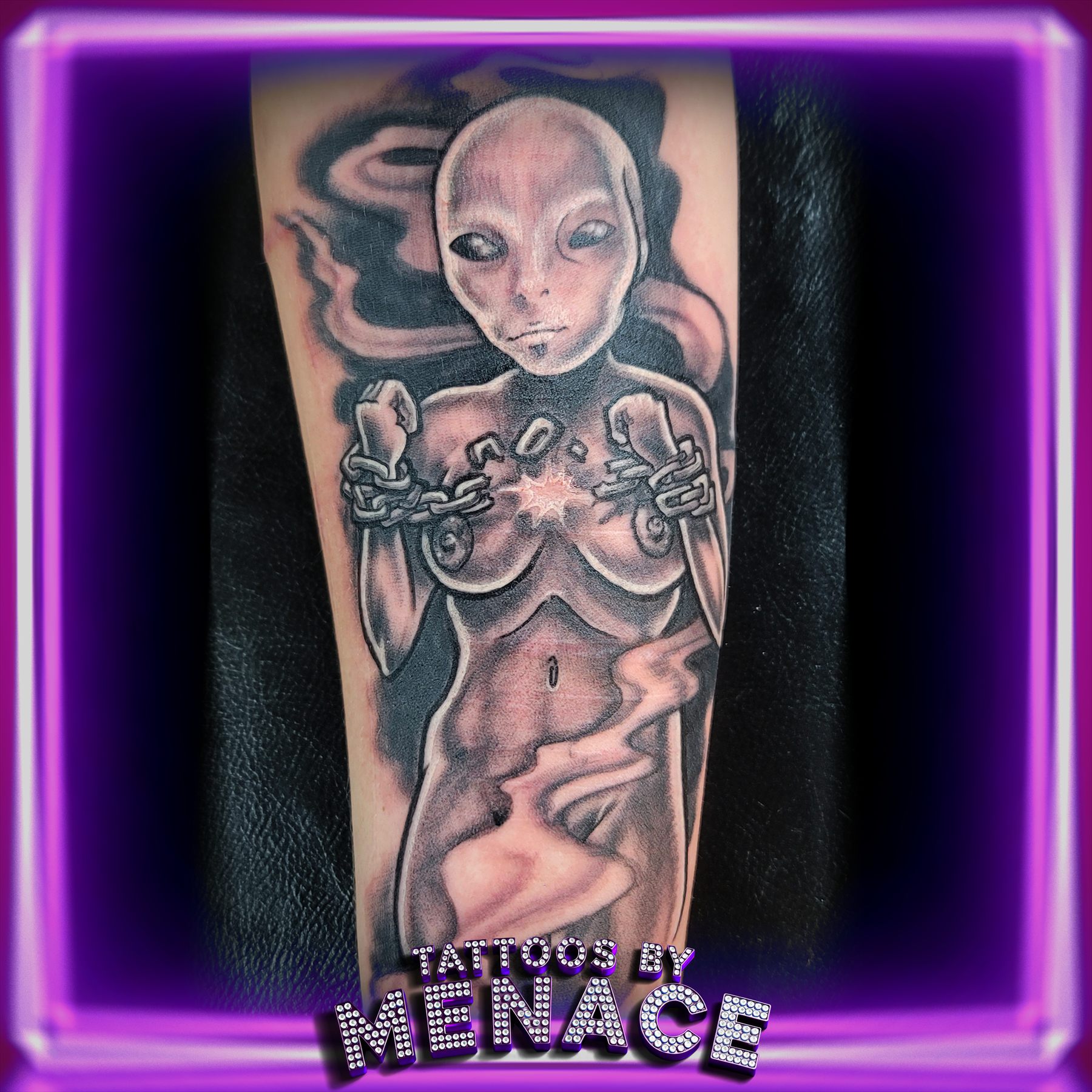 Color alien pin-up girl tattoo on the upper arm